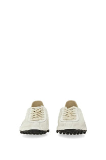 Maison Margiela women’s sneaker sprinters in cream-colored suede with black rubber soles and matching laces