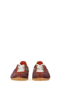 Maison Margiela women’s sprinters low top sneaker in maroon quilted suede with orange accents and white laces