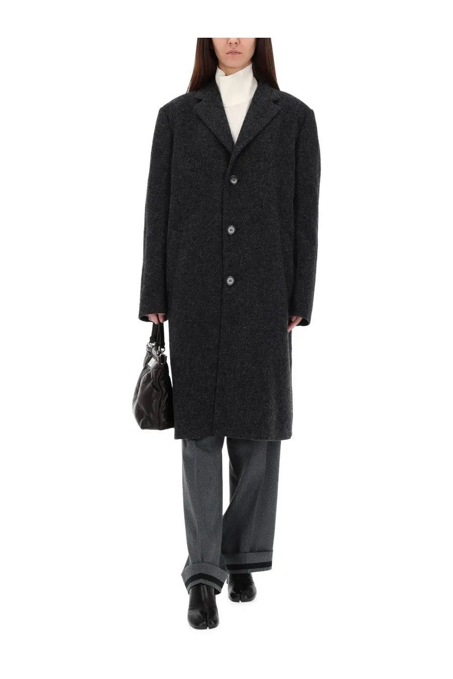 Black textured wool overcoat with silver buttons paired with maison margiela women’s tailored grey pants