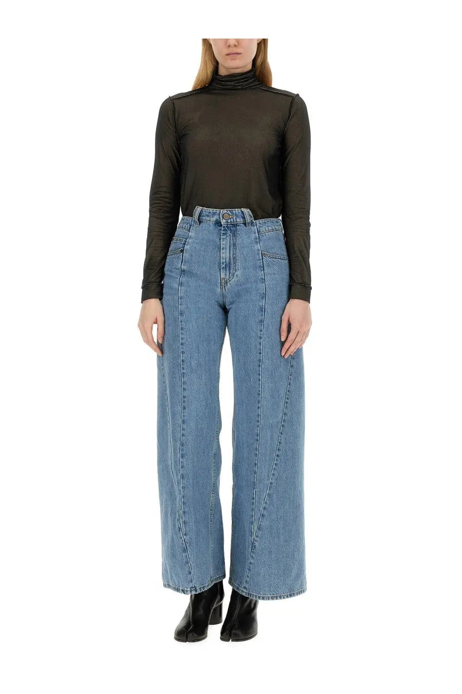 High-waisted light blue denim trousers with wide-leg cut and visible stitching paired with maison margiela black turtleneck bodysuit