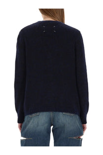 Dark navy wool cardigan by maison margiela with textured weave and white x-shaped stitching at the back neckline