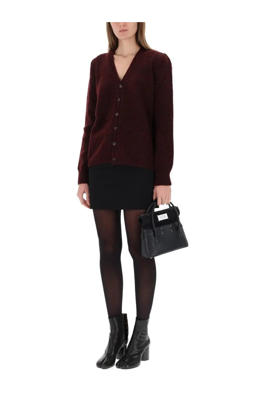 Black textured mini handbag with white label paired with maison margiela women’s red wool cardigan product image