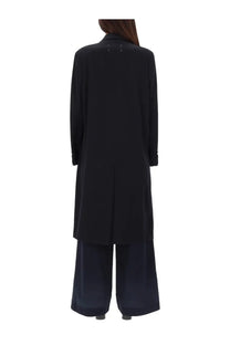 Back view of maison margiela women’s blue wool coat with subtle metallic button details on a long black coat
