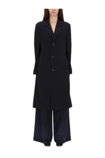 Maison Margiela women’s black oversized wool trench coat with structured collar and three-button front closure