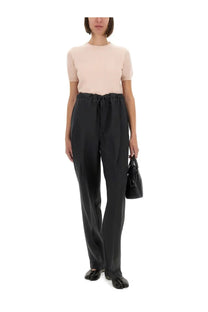 Black high-waisted wool trousers with drawstring waistband and subtle pleats paired with maison margiela blue crew neck shirt
