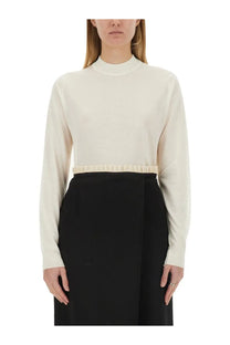 Maison Margiela women’s cream wool jersey long-sleeved turtleneck top with ruffled waistband detail