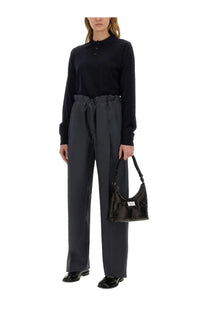 Black glossy leather hobo bag with white label on front featured with Maison Margiela women’s wool polo blue product