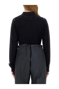 Maison Margiela women’s wool polo blue shown from the back with black long sleeves and white stitching at shoulders and back