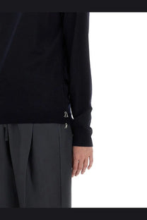 Maison Margiela women’s black wool long-sleeved top with subtle silver logo details at the cuffs