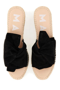 Manebi women’s black suede slide sandals with prominent knot bow and woven espadrille soles