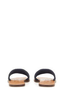 Manebi women’s slide sandal blue featuring black woven strap and tan leather sole