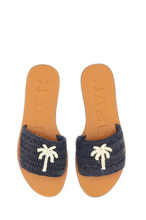 Navy blue woven manebi women’s slide sandal with white palm tree embellishments on the strap