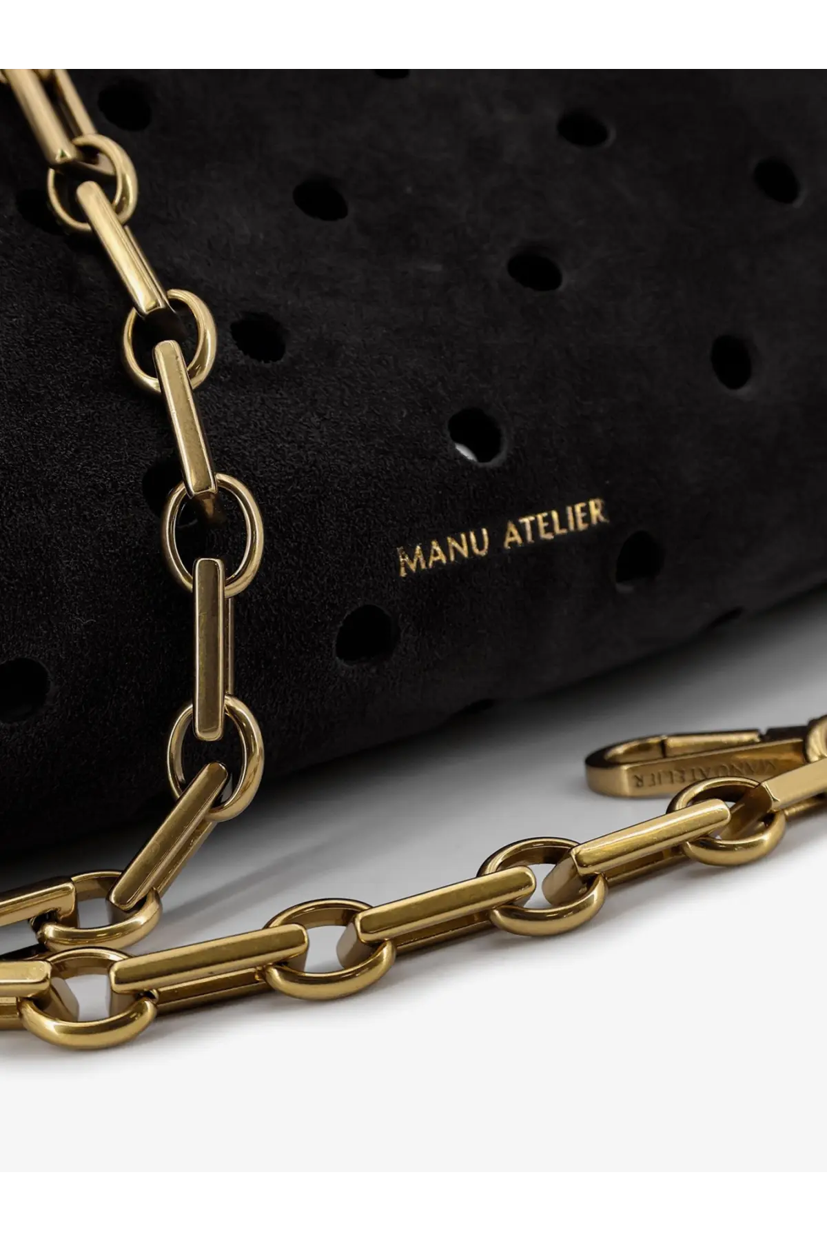 Manu Atelier women’s mini cylinder crossbody bag in black perforated suede with gold-tone paperclip chain strap