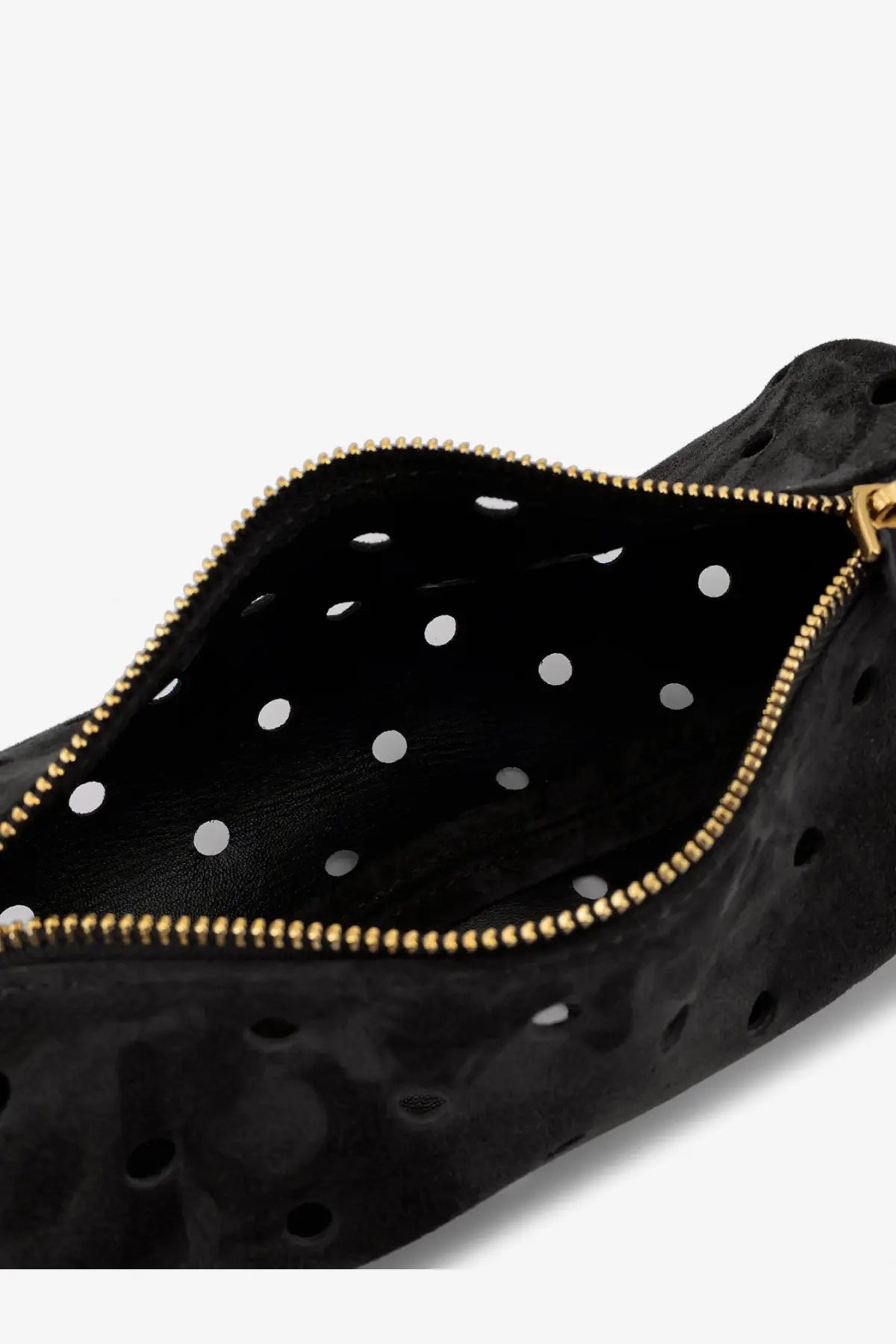 Manu Atelier women’s mini cylinder crossbody bag in black perforated suede with gold zipper and white polka dots lining