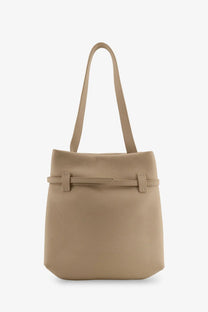 Beige leather tote bag with minimalist design and adjustable shoulder strap from Manu Atelier women’s collection