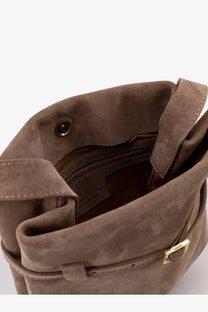 A taupe suede Manu Atelier women’s mini tote du jour shoulder bag with gold-tone buckle and zipper closure