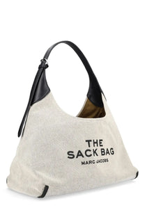Beige canvas shoulder bag with black leather trim and handles featuring the sack bag marc jacobs lettering