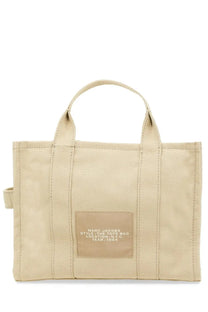 Beige canvas tote bag with matching handles and front patch label by marc jacobs from the medium tote collection