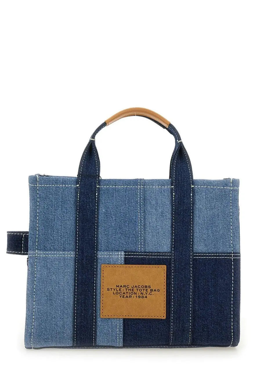 Marc Jacobs women’s borsa the medium tote denim blue featuring a blue denim patchwork and tan leather handles with brand label