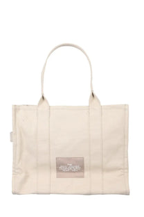 Marc Jacobs women’s borsa the tote large beige canvas bag with white handles and transparent label patch with black text