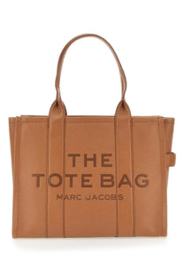 Tan leather marc jacobs tote bag with embossed the tote bag and marc jacobs lettering for everyday use