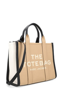 Beige and black marc jacobs medium tote bag with bold white lettering designed for everyday use