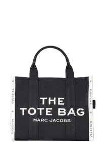 Black canvas tote bag with white embroidered the tote bag marc jacobs logo and side stripes with repeating text