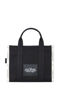 Black Marc Jacobs style tote bag with white ribbed side panels and central black label for everyday use