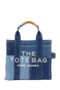 Denim patchwork tote bag with wooden handles and white embroidered Marc Jacobs branding in blue color