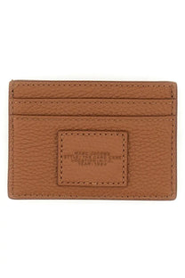 Tan leather marc jacobs women’s portacarte card case with embossed branding on a rectangular patch brown
