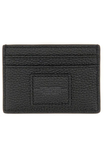 Black textured leather card holder with embossed Marc Jacobs logo on rectangular patch for women