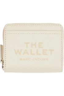 Cream-colored leather Marc Jacobs women’s compact mini wallet with embossed branding and zipper closure