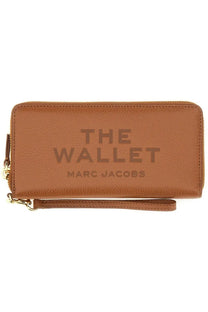 Tan leather marc jacobs women’s portafoglio continental beige wallet with embossed text and gold-tone zipper closure