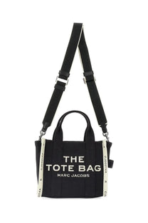 Marc jacobs women’s small black canvas tote bag with white lettering and striped shoulder straps