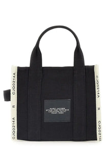 Marc Jacobs women’s small black canvas tote bag with white ribbed side stripes and a black rectangular label