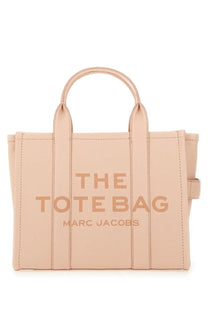 A blush pink leather tote bag embossed with the tote bag and marc jacobs in matching tone details