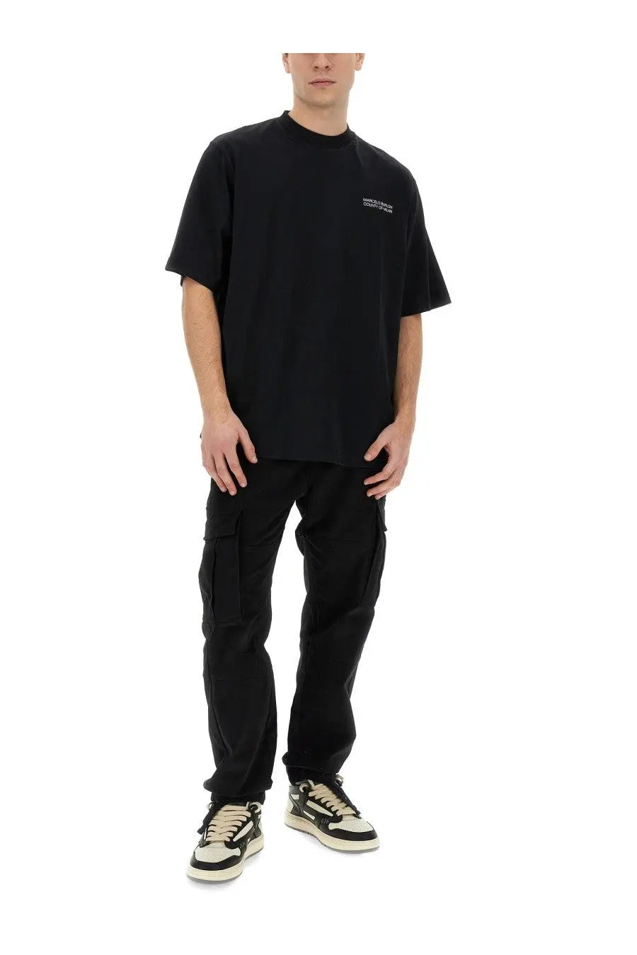 Black oversized t-shirt with a small white logo on the left chest worn with marcelo burlon county of milan men’s cargo pants