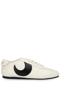 Cream-colored leather marine serre women’s astra sneaker with bold black crescent moon logo on the side
