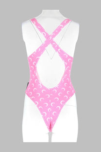 Marine Serre women’s pink one-piece swimsuit with white crescent moon pattern and crisscross back straps shown from back