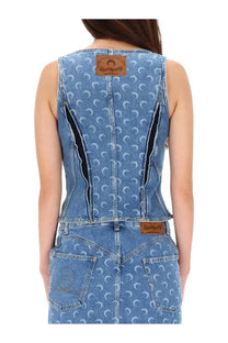Back view of marine serre women’s blue denim sleeveless jumpsuit with white crescent moon pattern and black zipper accents