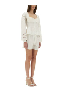White embroidered long sleeve top with floral detailing and square neckline paired with marine serre upcycled linen shorts