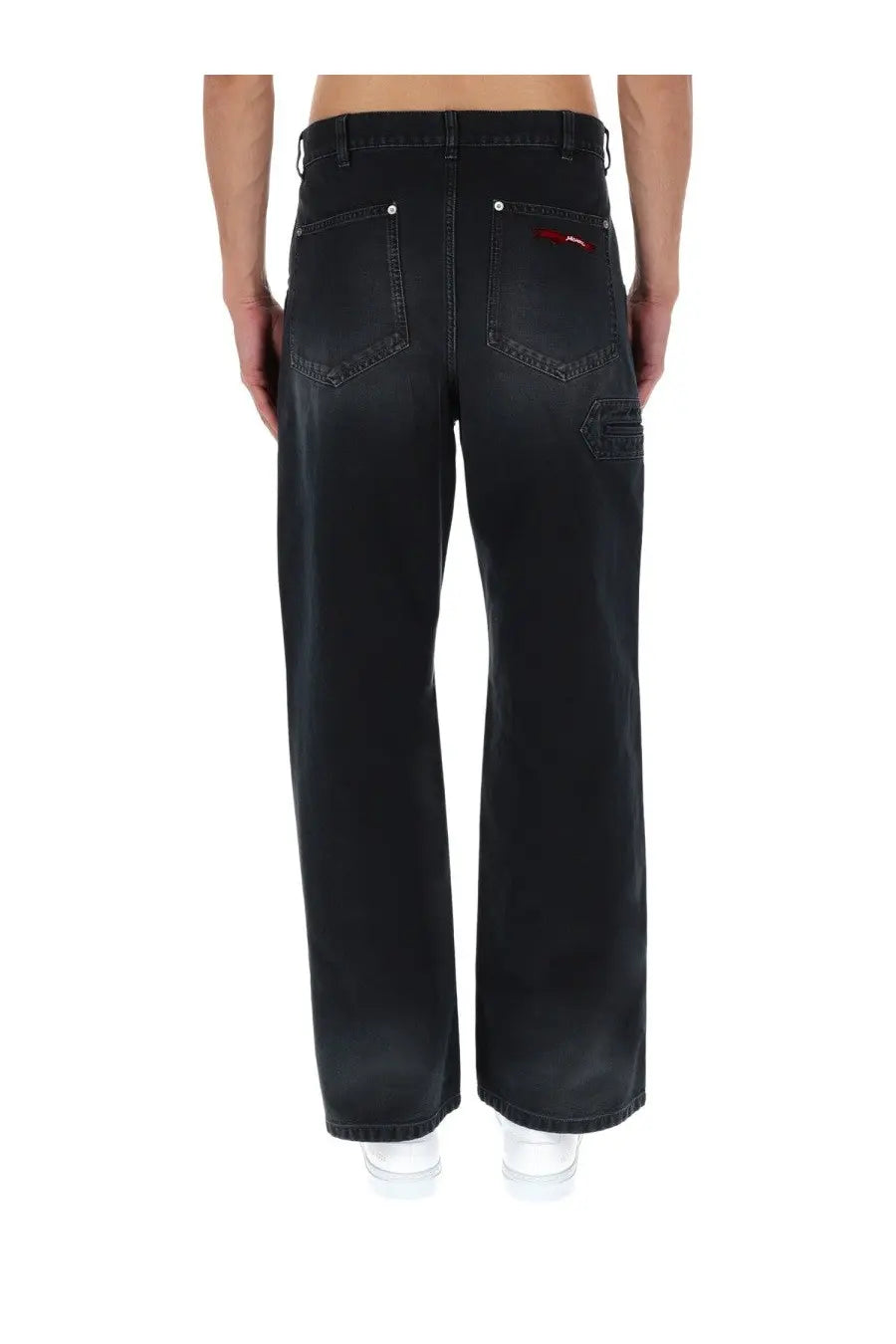Back side of marni men’s black denim jeans with wide-leg cut and subtle red logo on the back right pocket