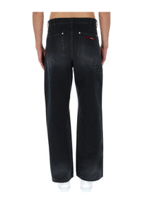 Back side of marni men’s black denim jeans with wide-leg cut and subtle red logo on the back right pocket