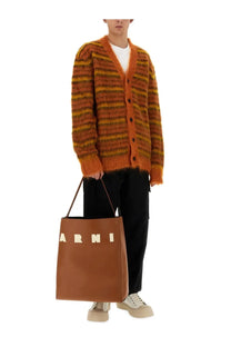 Brown leather tote bag with cream colored arni lettering paired with marni men’s blue wool pants product image