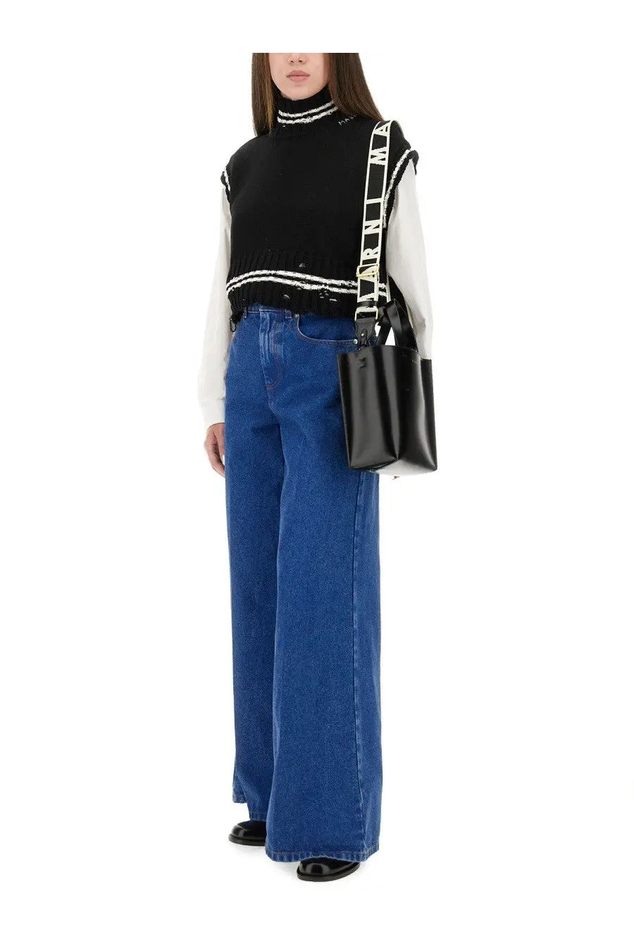 Black leather tote bag with white logo strap paired with marni women’s blue denim wide leg jeans