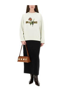 A tan leather handbag with a rectangular body and gold-tone marni lettering on the front paired with a white cotton sweatshirt