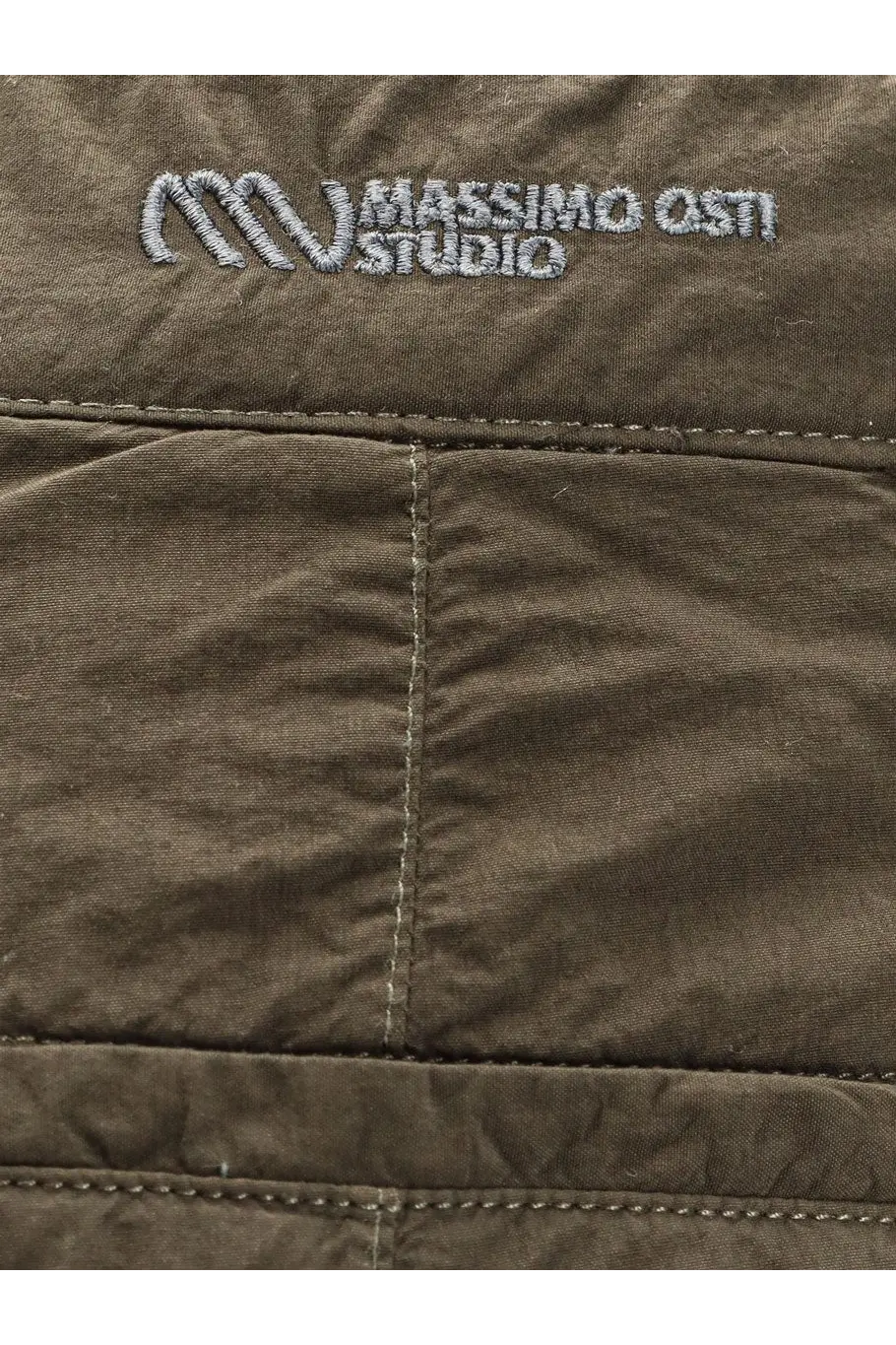 Olive green quilted jacket with silver embroidered massimo osti studio logo paired with brown nylon trousers