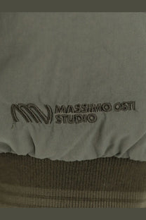 Light gray fabric with subtle embroidered massimo osti studio logo on the back of men’s padded nylon jacket brown