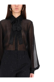 Black sheer blouse by max mara with subtle vertical shimmer and prominent bow at the neckline