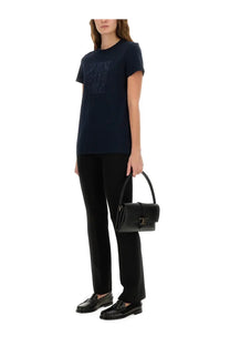 Black leather handbag with distinctive t-shaped clasp and top handle complementing max mara women’s bravo shirt blue